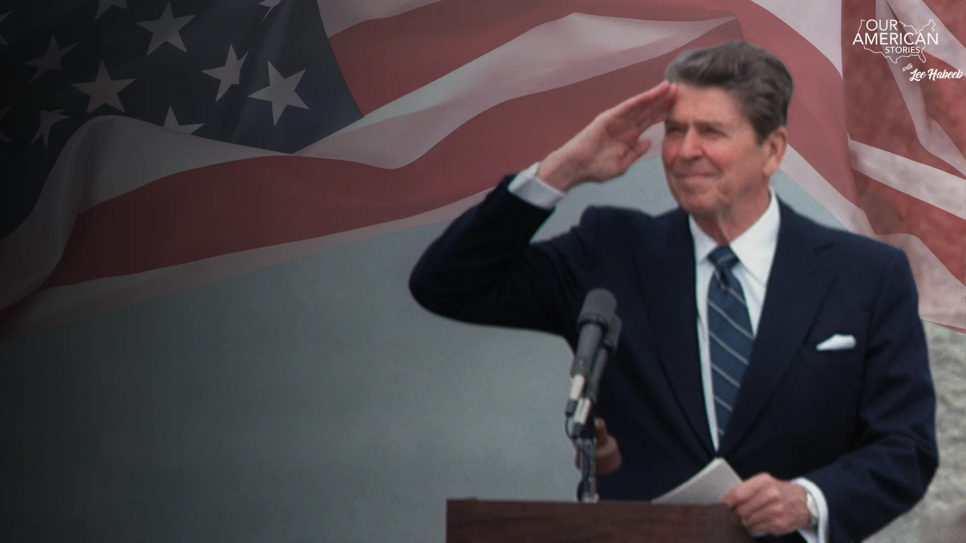 Man in a suit at a podium saluting, with a large U.S. flag backdrop and a 'Four American Stories' logo in the corner.